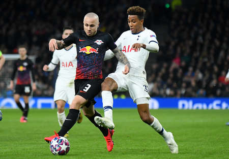 LONDON, ENGLAND - FEBRUARY 19, 2020: Angelino of Leipzig and Gedson Fernandes of Tottenham pictured during the first leg of the 2019/20 UEFA Champions League Round of 16 game between Tottenham Hotspur FC and RB Leipzig at Tottenham Hotspur Stadium.のeditorial素材
