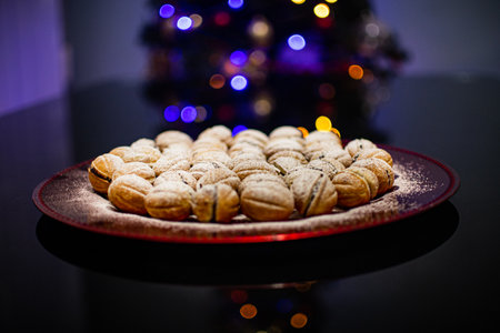 Traditional Christmas dinner dessert next to a mug with milk and bokeh lights from the Christmas treeの写真素材