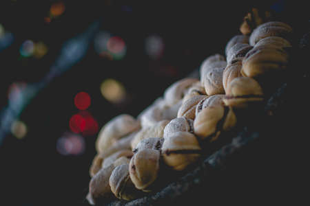 Moody picture of traditional Christmas bakeries on a place with bokeh effect and cozy atmosphere.の写真素材
