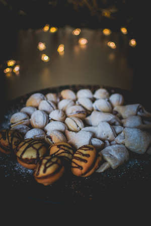 Moody picture of traditional Christmas bakeries on a place with bokeh effect and cozy atmosphere.の写真素材