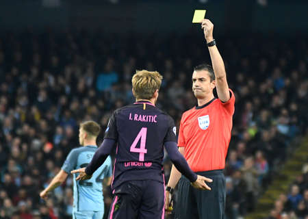 MANCHESTER, ENGLAND - NOVEMBER 1, 2016: Hungarian FIFA referee Viktor Kassai shows the yellow card...