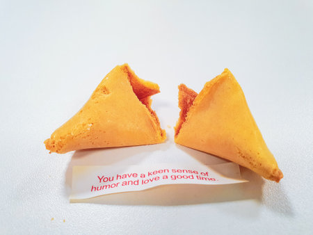 Broken fortune cookie with a positive vibe message under it and copy space around.