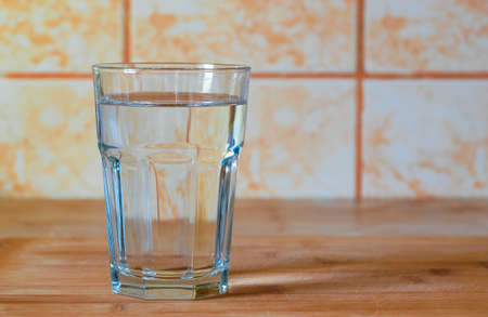 Glass of pure water on kitchen tableの写真素材