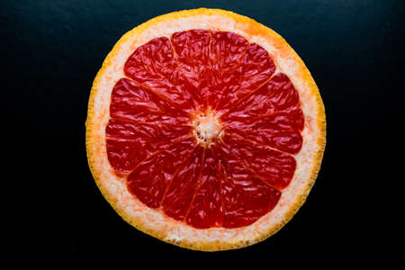 red grapefruit on black backgroundの写真素材