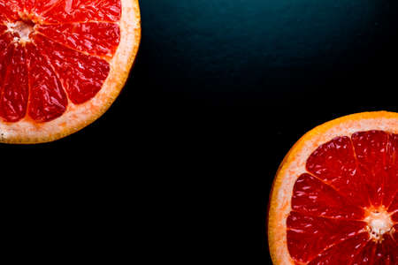 red grapefruit on black backgroundの写真素材