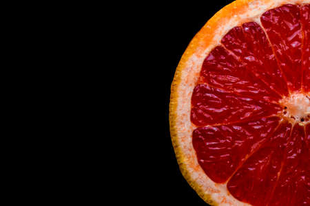 red grapefruit on black backgroundの写真素材