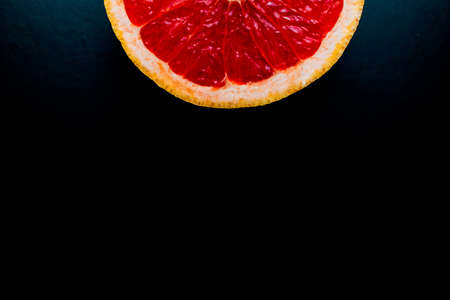 red grapefruit on black backgroundの写真素材