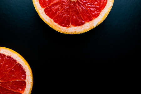 red grapefruit on black backgroundの写真素材