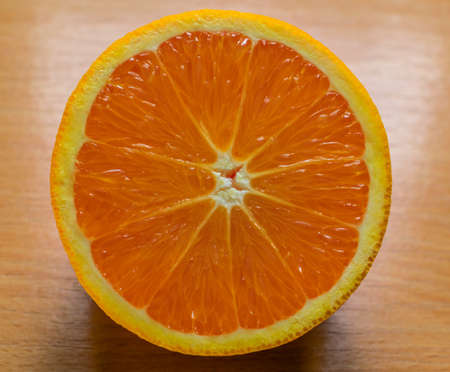 Orange, half of orange, orange lobule and basket with oranges on the wooden tableの写真素材