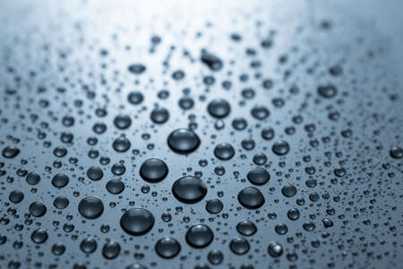 Drops of water on a blue glass texture backgroundの写真素材
