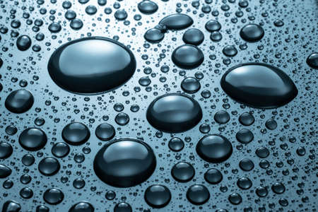 Drops of water on a blue glass texture backgroundの写真素材