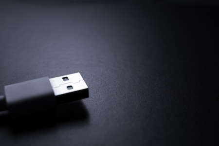 Closeup of USB cable. Isolated on black backgroundの写真素材