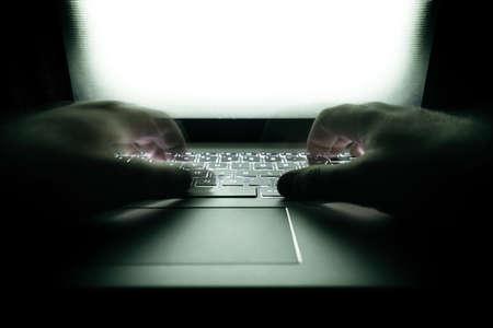 Hacker using laptop.の写真素材