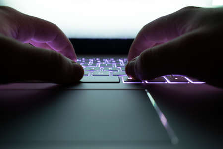 Hacker using laptop.の写真素材