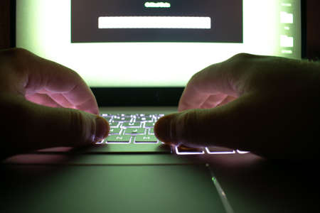 Hacker using laptop.の写真素材