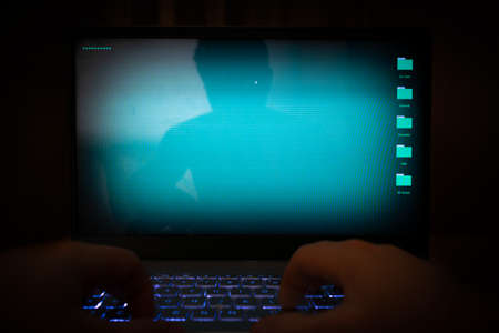 Hacker using laptop.の写真素材