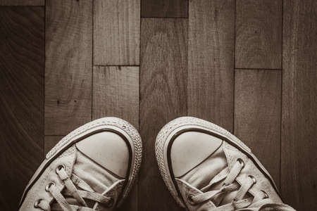 Old shoes on brown wood backgroundの写真素材