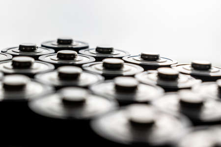 Closeup of pile of used alkaline batteries. Close up colorful rows of selection of AA batteries energy abstract background of colorful batteries.の写真素材