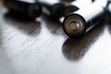Closeup of pile of used alkaline batteries. Close up colorful rows of selection of AA batteries...