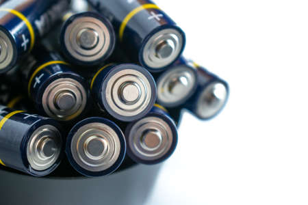Closeup of pile of used alkaline batteries. Close up colorful rows of selection of AA batteries...