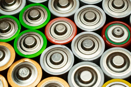 Closeup of pile of used alkaline batteries. Close up colorful rows of selection of AA batteries...