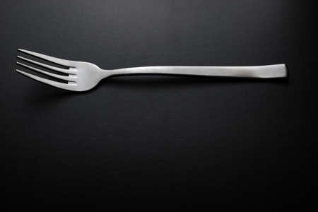 Silver fork on black backgroundの写真素材