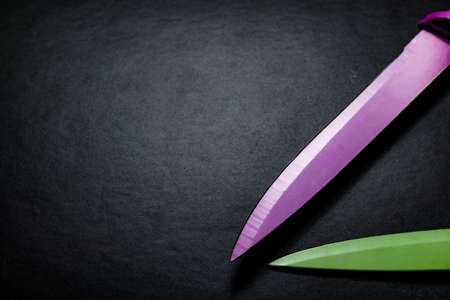 colored knives on black backgroundの写真素材