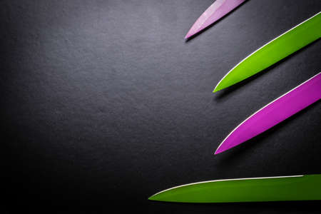 colored knives on black backgroundの写真素材