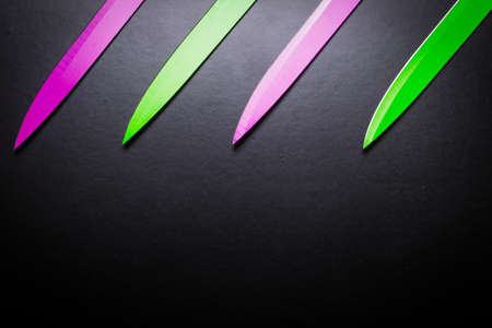 colored knives on black backgroundの写真素材