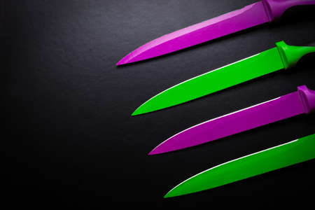 colored knives on black backgroundの写真素材