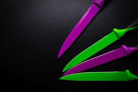 colored knives on black backgroundの写真素材