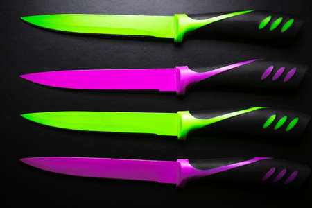 colored knives on black backgroundの写真素材