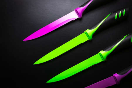 colored knives on black backgroundの写真素材