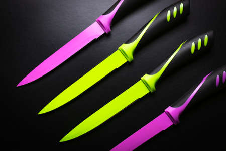colored knives on black backgroundの写真素材