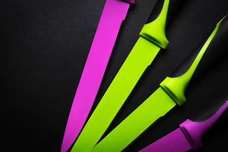 colored knives on black backgroundの写真素材