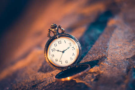 An old pocket watch photographed close to the blurred backgroundの写真素材
