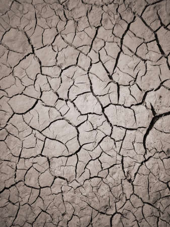 Texture of dry cracked earth. The desert background. The global shortage of water. Deep cracks in brown land as symbol of hot climate and drought.の写真素材