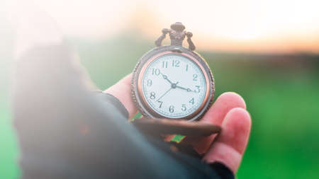 An old pocket watch in your handの写真素材
