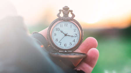An old pocket watch in your handの写真素材