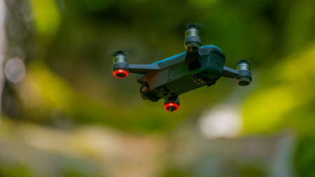 flying drones on green background blurredの写真素材