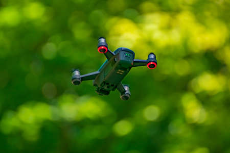 flying drones on green background blurredの写真素材