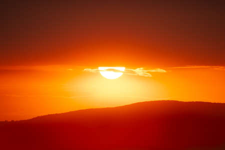 Beautiful sunset sky above clouds with dramatic light.の写真素材