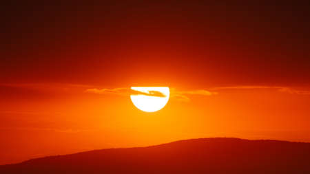 Beautiful sunset sky above clouds with dramatic light.の写真素材