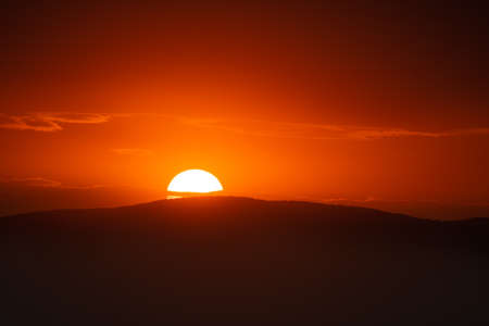 Beautiful sunset sky above clouds with dramatic light.の写真素材