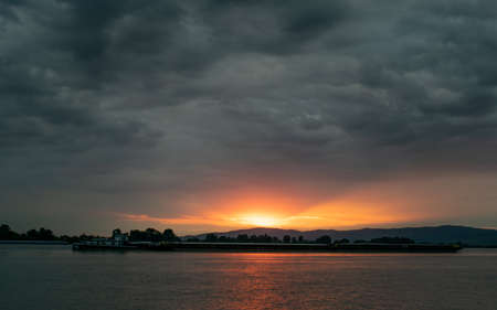 Dramatic stormy dark cloudy sky, natural photo backgroundの写真素材