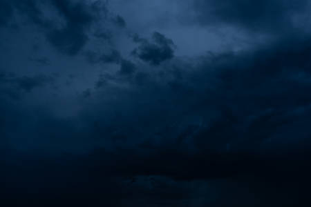 Dramatic stormy dark cloudy sky, natural photo backgroundの写真素材