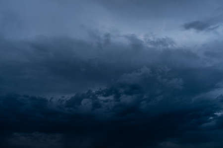 Dramatic stormy dark cloudy sky, natural photo backgroundの写真素材