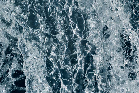 Blue and turquoise water with irregular wave structureの写真素材