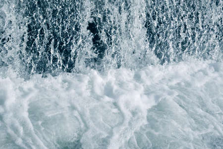 Blue and turquoise water with irregular wave structureの写真素材