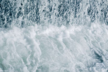Blue and turquoise water with irregular wave structureの写真素材